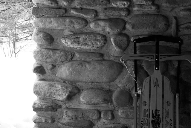 Worlds End State Park Cabin 3 sled and stone cabin wall BW