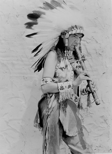 Ojibwa performer playing flute, 1937