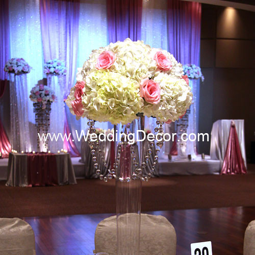 A tall pilsner vase wedding centerpiece with hanging crystals hydrangeas