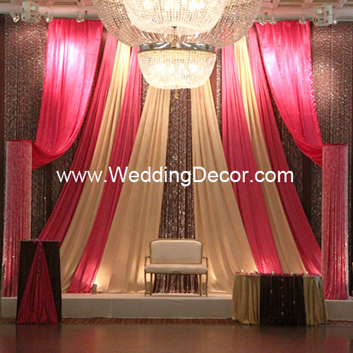 A fuchsia brown gold wedding backdrop with cake tabke loveseat and lots 