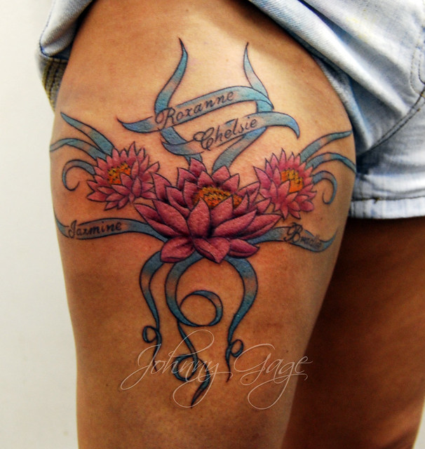 lotus and names tattoo Tattooed by Johnny at The Tattoo Studio