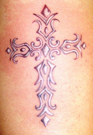 Gray wash and White tribal cross Done on forearm by Libby