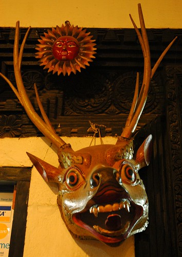 Deer mask, Tibetan style, ritual masquerade, wood, sun, business hallway, Boudha, Kathmandu, Nepal by Wonderlane