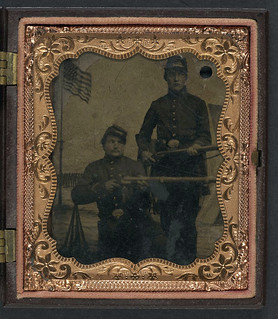 [Brothers William and Philip J. Letsinger of Company D, 14th Indiana Regiment posing with rifles in front of Camp Michigan painted backdrop] (LOC)