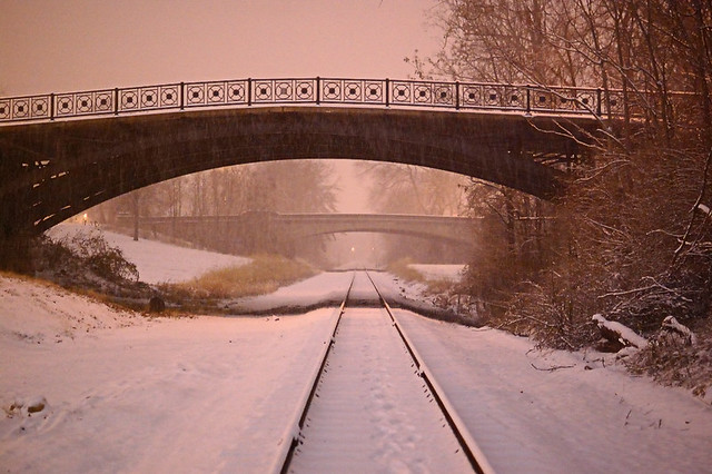 Carondelet Park, in Saint Louis, Missouri, USA - railroad track and bridges, at night, in the snow