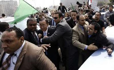 United Nations Secretary General Ban Ki-moon is shielded by guards after coming under attack by demonstrators opposing the imperialist bombing of Libya which was justified by Security Council action. by Pan-African News Wire File Photos