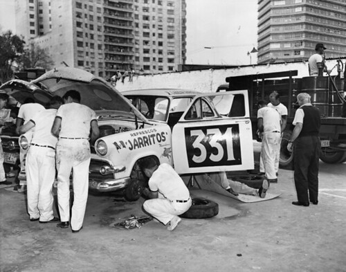 Mechanics working on race car at La Carrera Panamericana road race, Mexico, May 1954