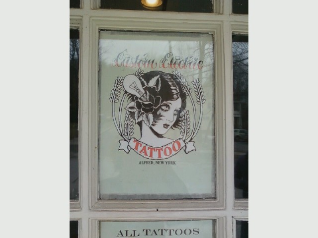 A closeup of the design and logo of the ustom edition tattoo shop on the 