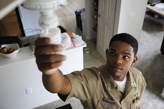 Sailor switches his lights to high efficient bulbs as part of an energy conservation initiative in Hawaii