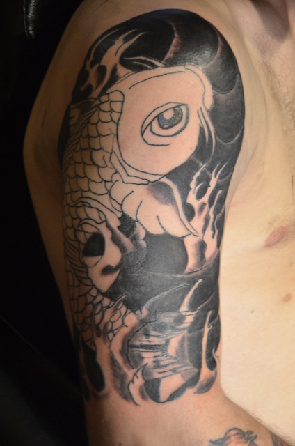 Black and white Koi fish upper arm tattoo