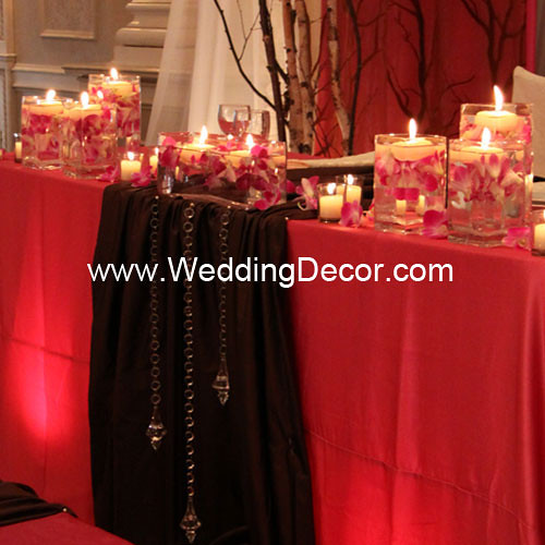 Head table decorations for a wedding reception in fuchsia and brown with 