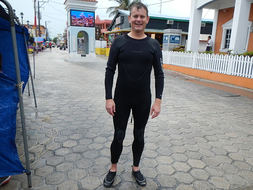 Erik in wetsuit on Front street San Pedro, smiling