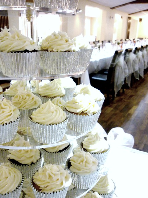A white winter wonderland inspired cupcake tower with a white and silver 