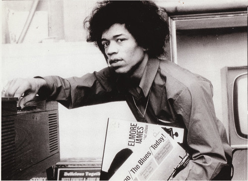 Jimi Hendrix listening to his blues records. His music was heavily inspired and influence by indigenous African American culture. His records continue to sell over 40 years after his emergence as a pop artist. by Pan-African News Wire File Photos