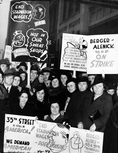Workers on W. 35th St. between 7th and 8th Ave., the area known as China Town, strike for improved conditions, 1940. One sign suggests Franklin D. Roosevelt would say "End Starvation Wages" and Berger - Alenick would reply "Not in Our Sweat Shops"