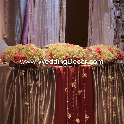 Head table decorations for a wedding reception in dusty rose and silver with