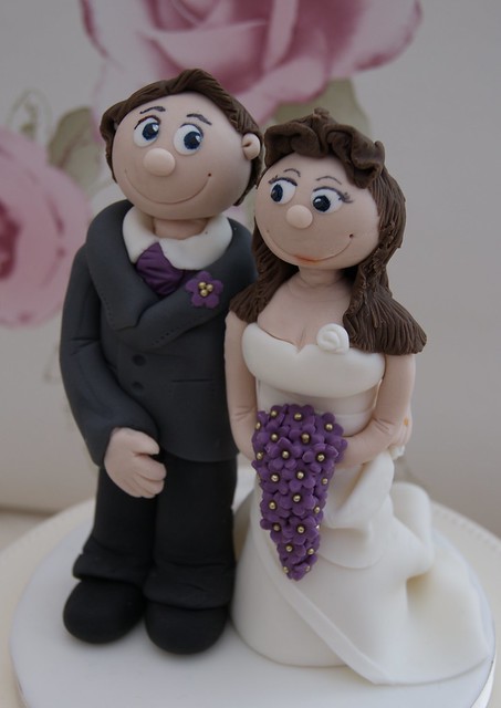 Bride and groom wedding cake topper complete with teardrop flower bouquet
