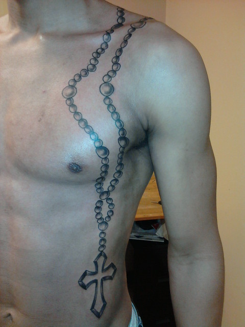 tattoo of rosary on chest tattooed by Cash Parish custom drawn on skin by