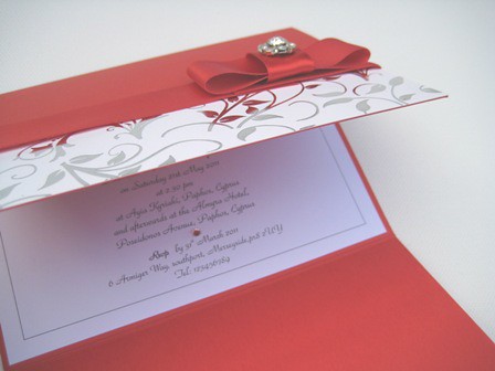 handmade red and silver wedding invitations in wallet with red satin ribbon