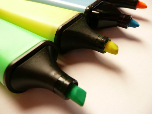 Close up / Macro of four felt-tip-pencils in green, yellow, blue and orange