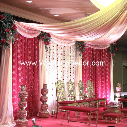 A wedding mandap in red ivory and gold satin with sparkle fabric 