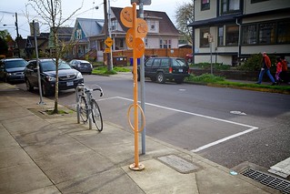 Car share parking space with iconic sign post that doubles as bike parking.