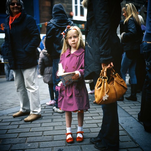 Girl with red shoes at parade.