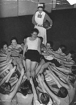 Members of the Nazi girls' organization, the League of German Girls (BDM), do a group exercise. Dresden, Germany, December 1936