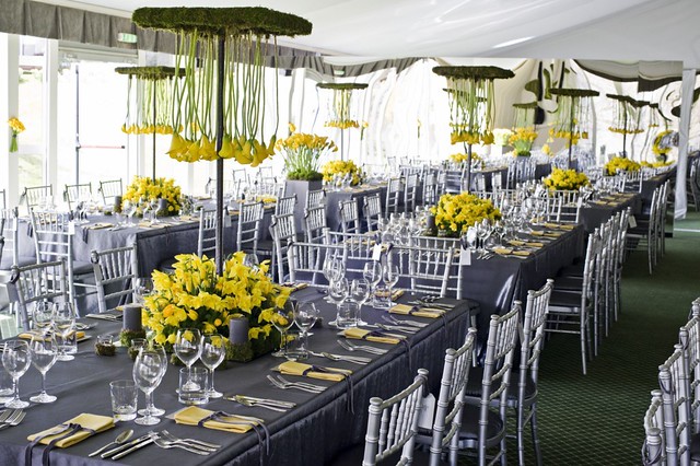 Our silver taffeta tablecloths complement the striking yellow of the flowers