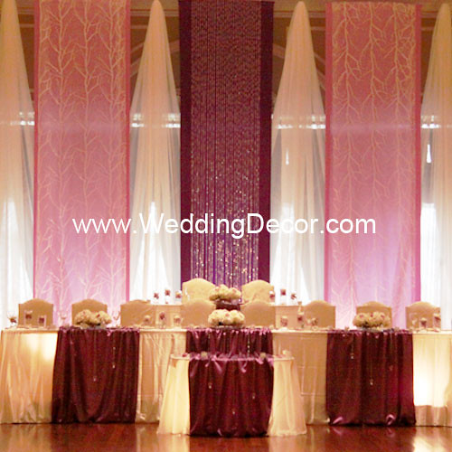 A royal purple lavender and white wedding backdrop with matching head table