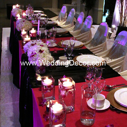 Head table decorations for a wedding reception in black and fuchsia with