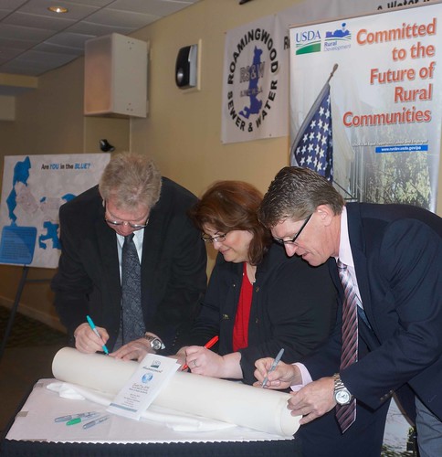 Tom Williams, PA RD State Director, Jacki Ponti-Lazaruk, RD WEP Program Assistant Administrator, and Jack Lennox, Roamingwood Water & Sewer Association General Manager, ceremoniously sign a portion of the new pipe that will replace old lines in the current system, making the system more energy, cost and water efficient. 