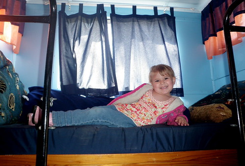 Gary's granddaughter, Kyla, sits in one of two twin beds in the "Happy Everly".