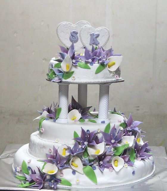 4 tier Purple Lilies and anthrium floral decorated fondant wedding cake