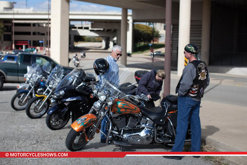 A show fan parks their custom Harley in the free motorcycle parking lot