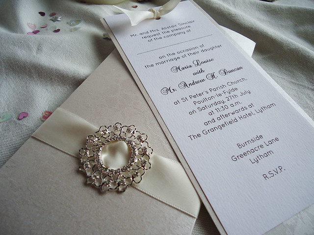 Diamond Wedding Invitations A large faux diamond bucke decorates this 