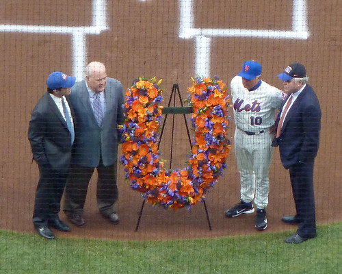 Terry Collins receives a floral wreath from the Shea family