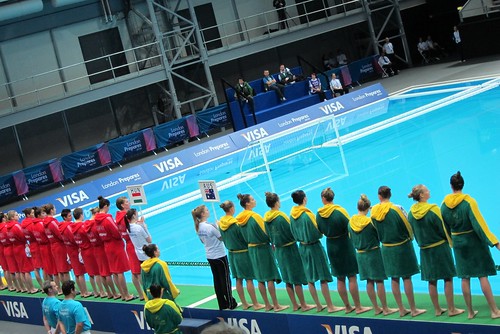 Water polo teams line up in dressing gowns