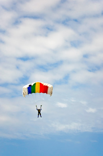 Parachute jumper descending on cloudy day