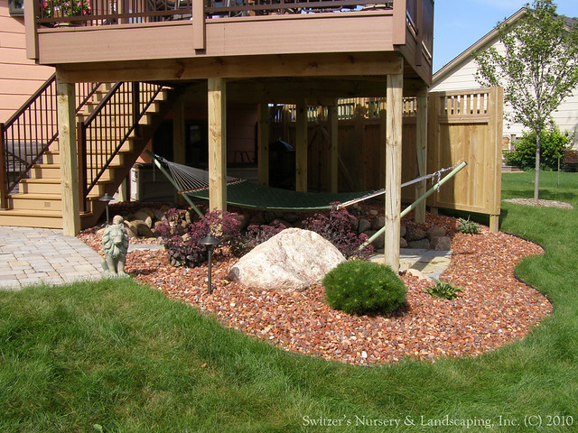 Incorporating the space under the deck can make the maintenance that much easier. The space can be delightful and pleasing to look at as part of the landscape.