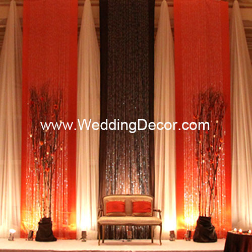 A burnt orange brown and ivory wedding backdrop with loveseat 