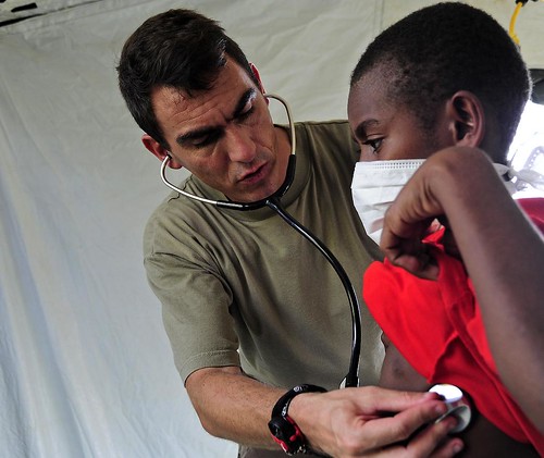 Doctor uses a stethoscope to examine a child