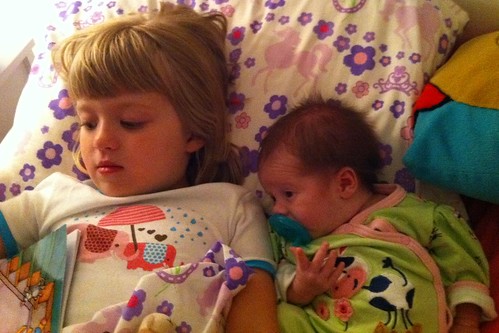 Sisters cozied up at bedtime