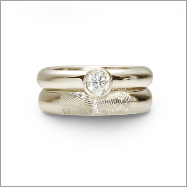 The wedding band is a Fingerprint ring which is hand engraved with your