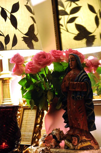 Statue of Our Lady of Guadalupe, with angel, pink roses in a pink vase, lamp, candle, shells, mirror, Wedgwood, Seattle, Washington, USA by Wonderlane