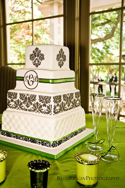 Four squaretiered cake done in white fondant with black white green 