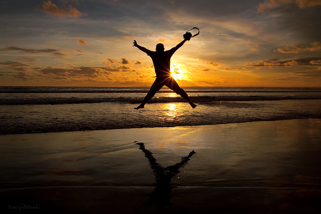 A photographer jumping for joy during sunset - How to be a Happy Photographer