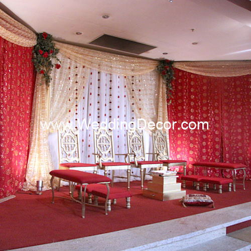 A wedding mandap in red gold and ivory To see additional wedding decor 