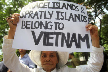 A woman holds a placard supporting Vietnam in a protest demanding China to stay out of their waters following China's increased activities around the Spratly Islands and other disputed areas, in Hanoi, Vietnam on June 12. by Pan-African News Wire File Photos