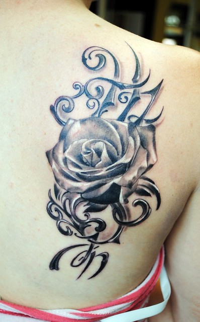 Black and grey female tattoo with rose and initials HZJN